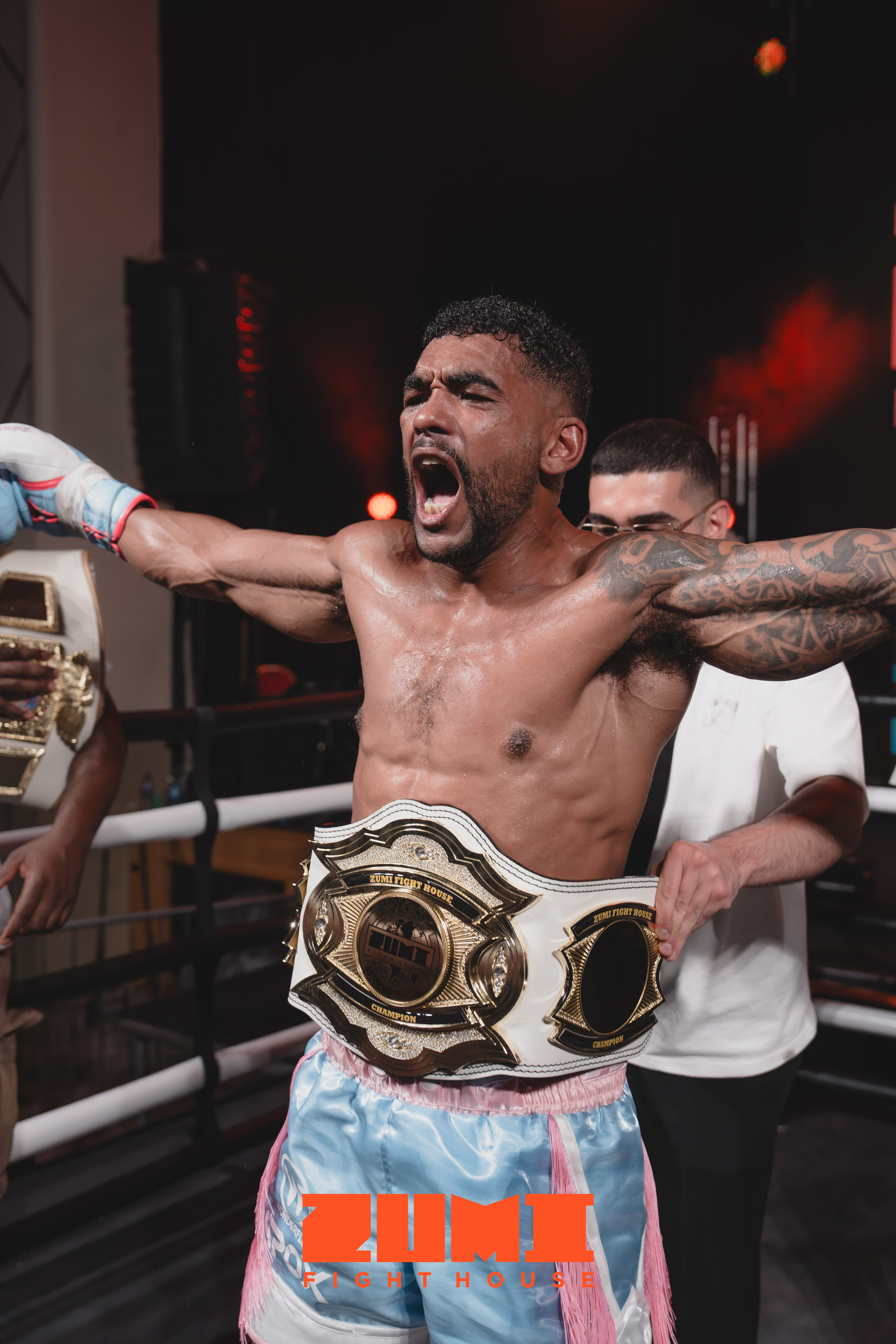 Zumi Fight House champion celebrating with title belt